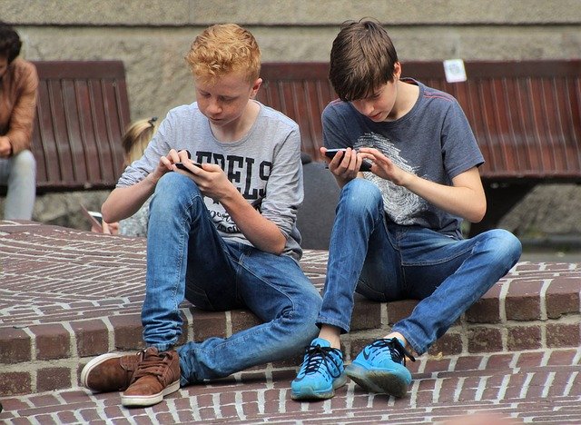 Boys playing mobile games