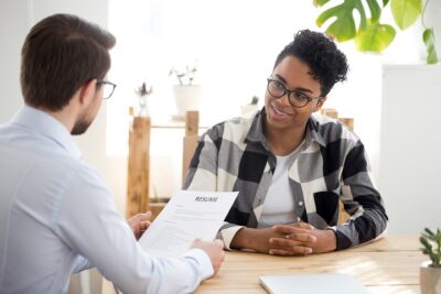 Male employer interview smiling black female applicant
