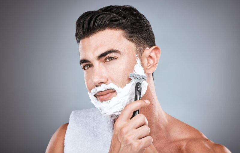 Face shaving cream and man with razor